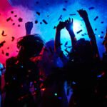 Silhouettes of dancers moving in confetti